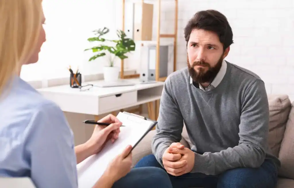 Early Middle Age Crisis Stressed Young Man Talking To Psychologist