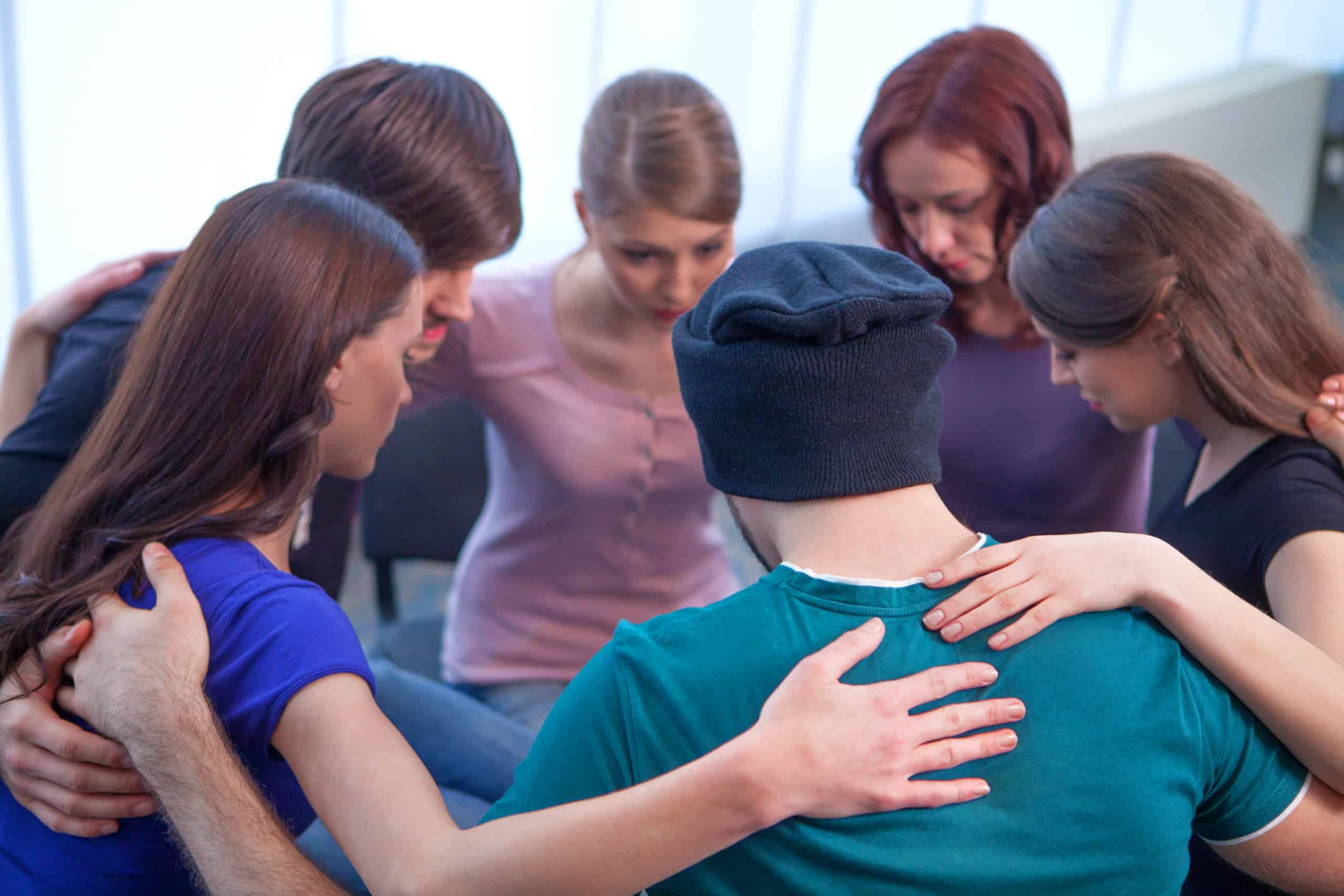 Group Of People Sitting In A Circle Hugging Each Other for a Group Therapy Sessions