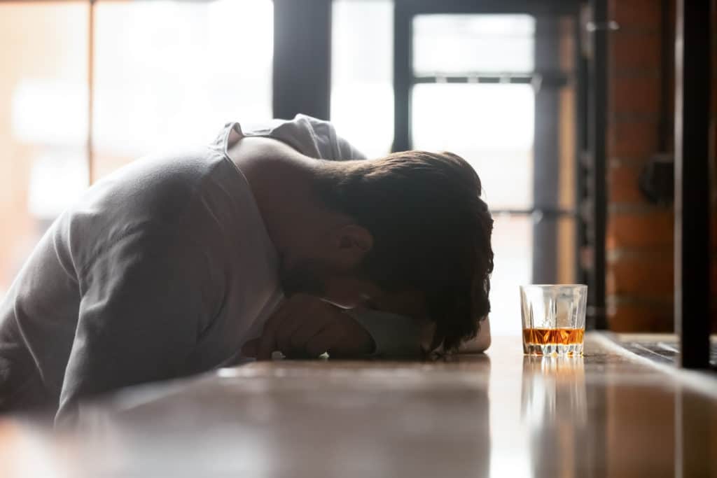 Drunk Boozy Man Sleeping Lying On Bar Counter After Drinking