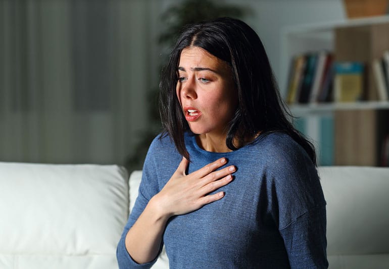 woman wearing blue blouse dealing with panic attacks