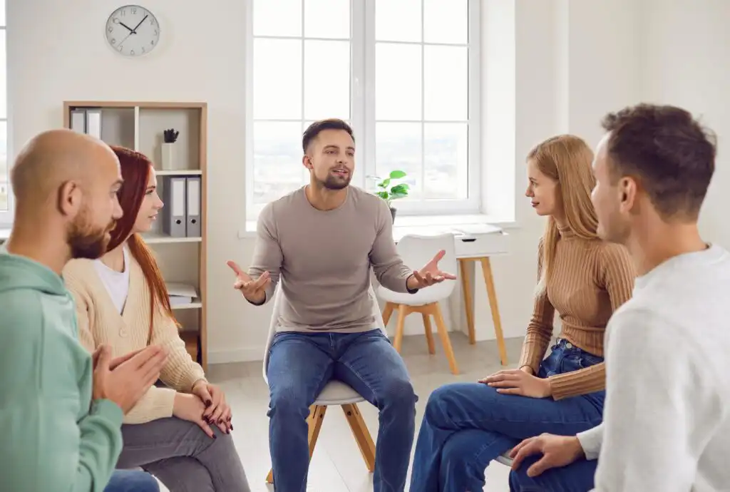 Professional,Psychotherapist,Leading,Group,Of,Young,Adults,,Helping,Male,And