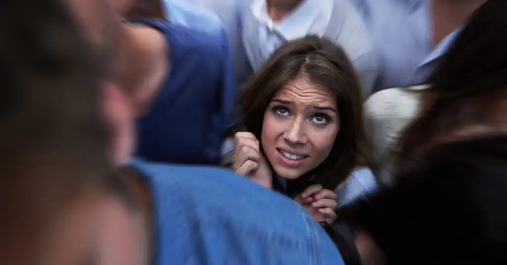 Anxious individual surrounded by a crowd, symbolizing the emotional and psychological symptoms that may occur during fentanyl withdrawal