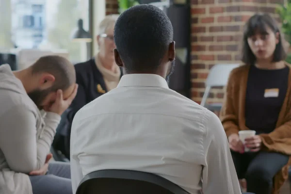 Close up of african american man discussing alcohol addiction at aa therapy session