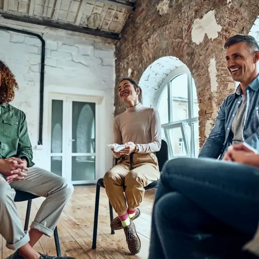 Group,Therapy,Session,Sitting,In,A,Circle,And,Laugh.,Positive